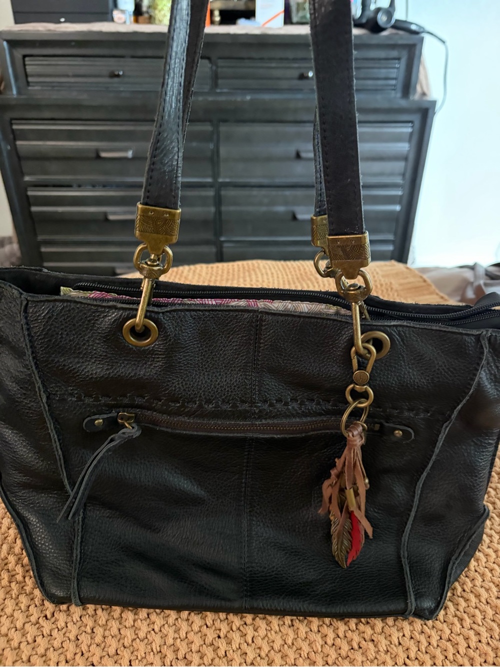 The Sak Black Leather Tote Bag with Tassel Charm